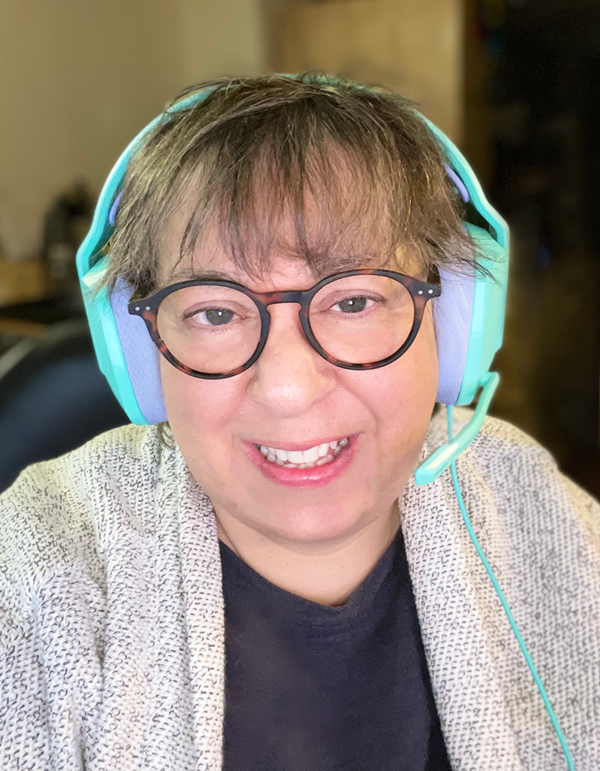 Bevi Chagnon, wears bright aqua headphones when teaching online classes.
